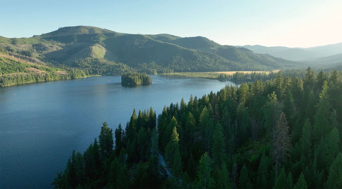 A forested lake in the hills near Rathdrum. Onyx & Oak Homes builds custom homes in Rathdrum, Idaho.