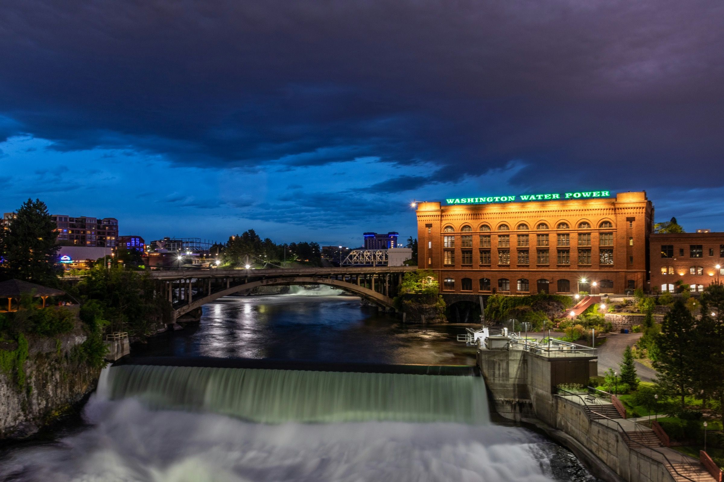 Spokane Falls in downtown Spokane at dusk. Onyx & Oak Homes builds custom homes in Spokane, Washington.